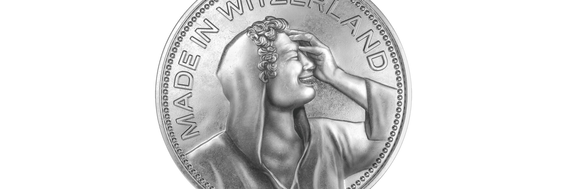 Fünflieber-ähnliche Münze mit einem lachenden Portrait und dem Titel "Made in Witzerland"